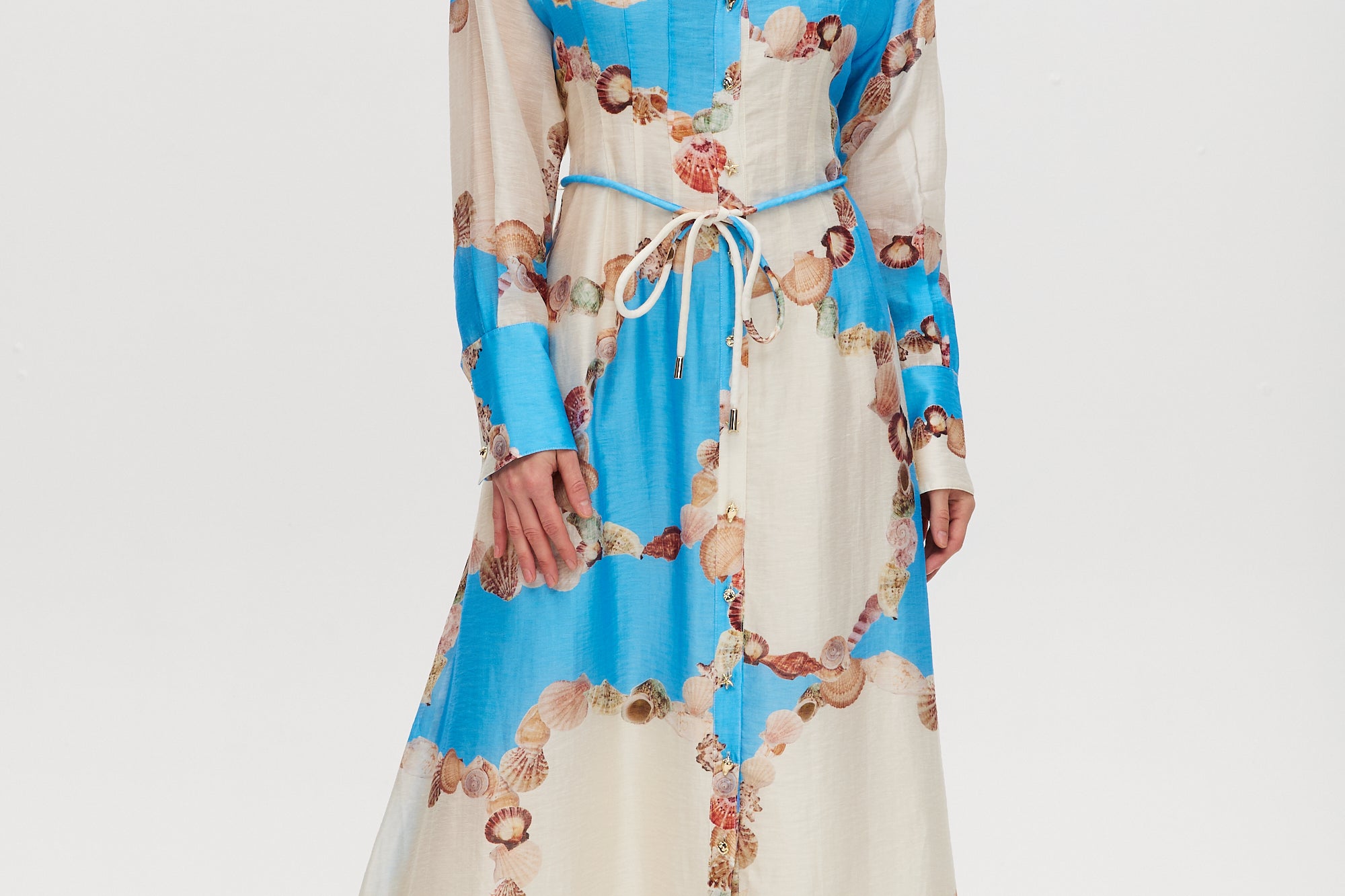 Azure maxi dress with floral print, linen blend, classic collar, long sleeves, button-front, and adjustable waist.