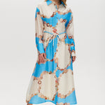 Azure maxi dress with floral print, linen blend, classic collar, long sleeves, button-front, and adjustable waist.