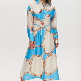 Azure maxi dress with floral print, linen blend, classic collar, long sleeves, button-front, and adjustable waist.