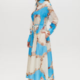 Azure Floral Printed Linen Blend Maxi Dress featuring a classic collar, long sleeves, button-front design, and adjustable waist by Hilary Radley.