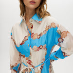 Azure Floral Printed Linen Blend Maxi Dress featuring a classic collar, long sleeves, button-front design, and adjustable waist by Hilary Radley.