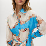 Azure Floral Printed Linen Blend Maxi Dress featuring a classic collar, long sleeves, button-front design, and adjustable waist by Hilary Radley.
