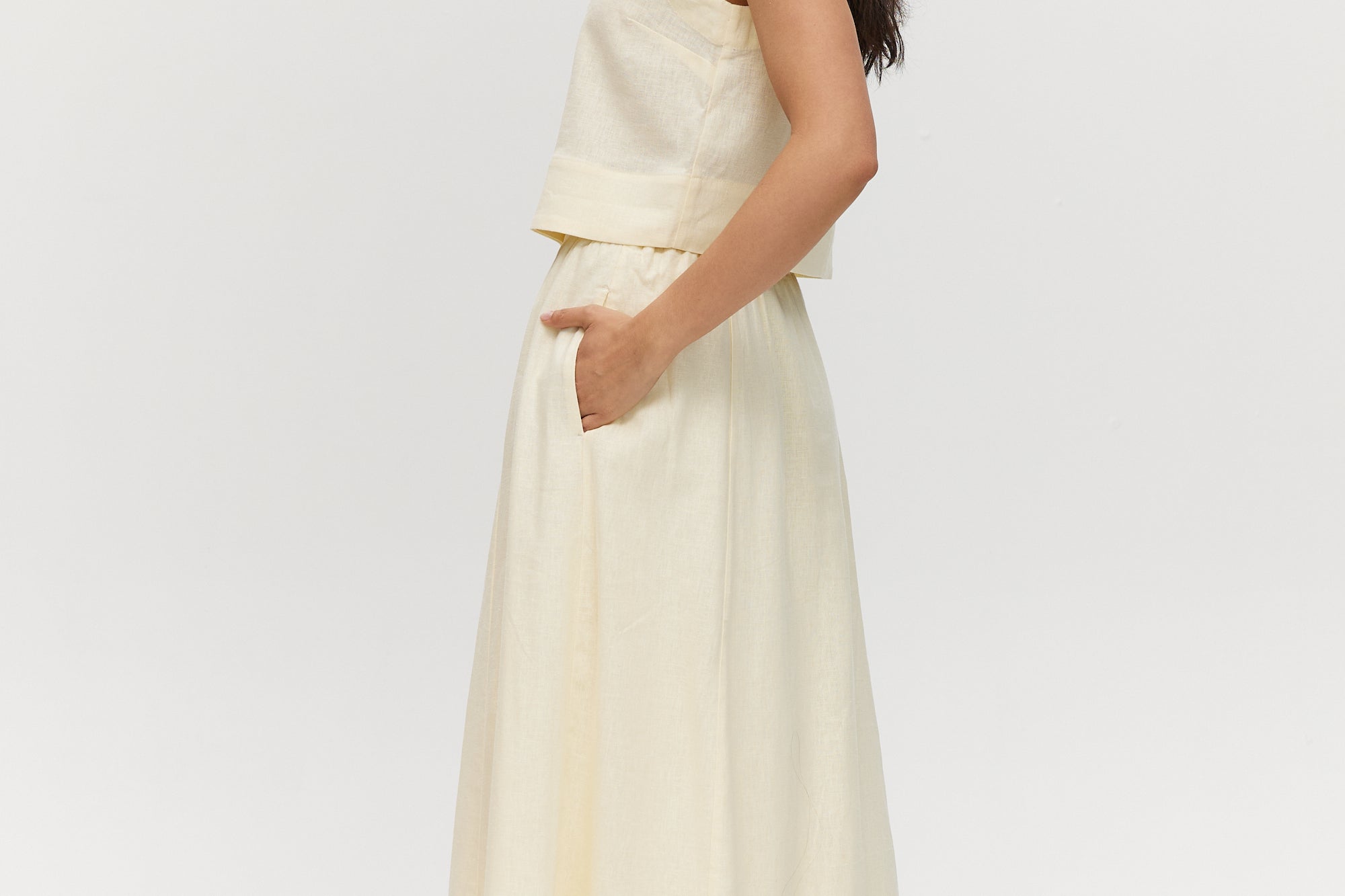 Yellow linen blend pull-on pleated midi skirt featuring pockets and an elastic waistband by Hilary Radley.
