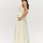 Yellow linen blend pull-on pleated midi skirt featuring pockets and an elastic waistband by Hilary Radley.