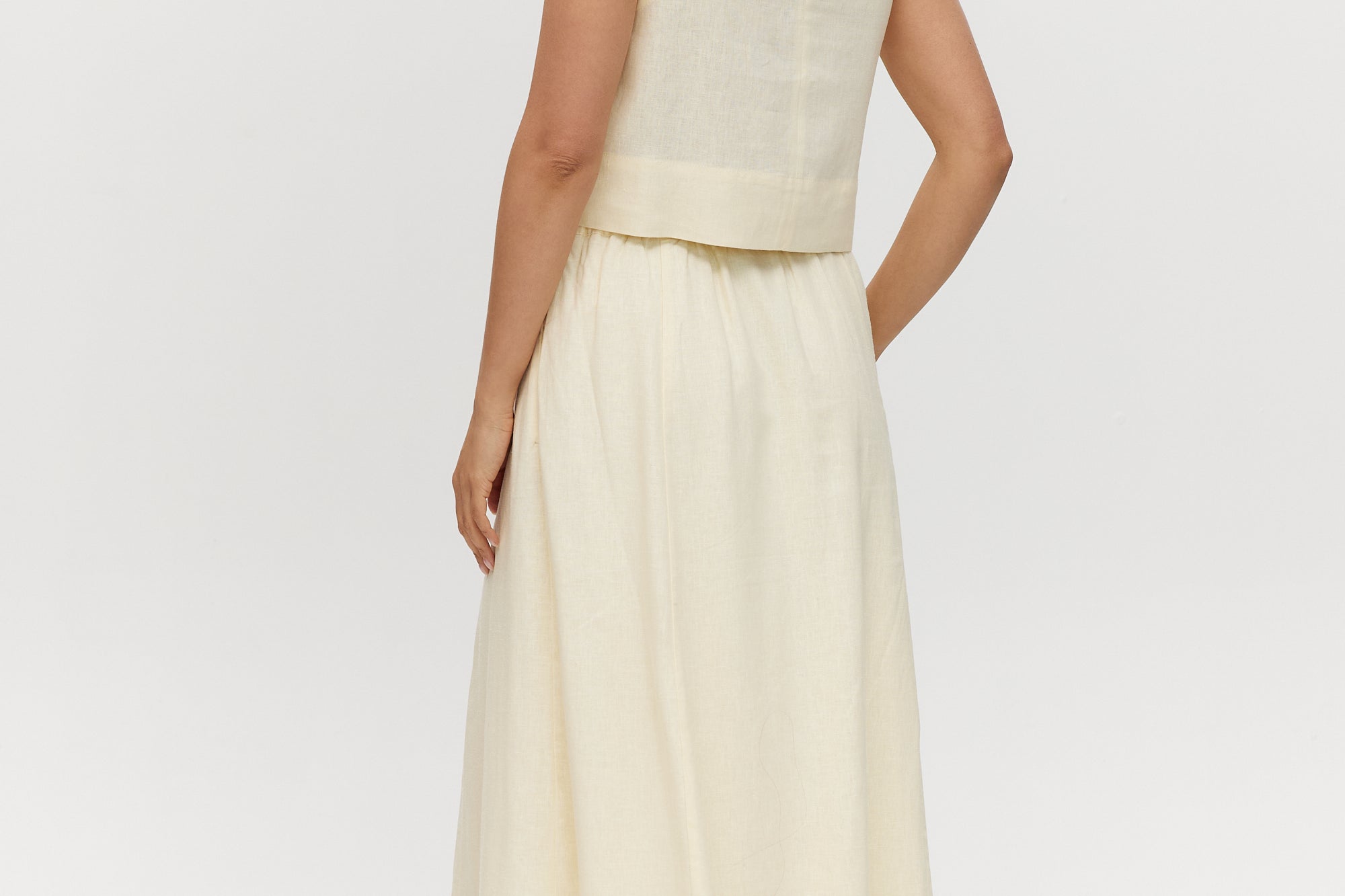 Yellow linen blend pull-on pleated midi skirt featuring pockets and an elastic waistband by Hilary Radley.