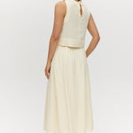Yellow linen blend pull-on pleated midi skirt featuring pockets and an elastic waistband by Hilary Radley.
