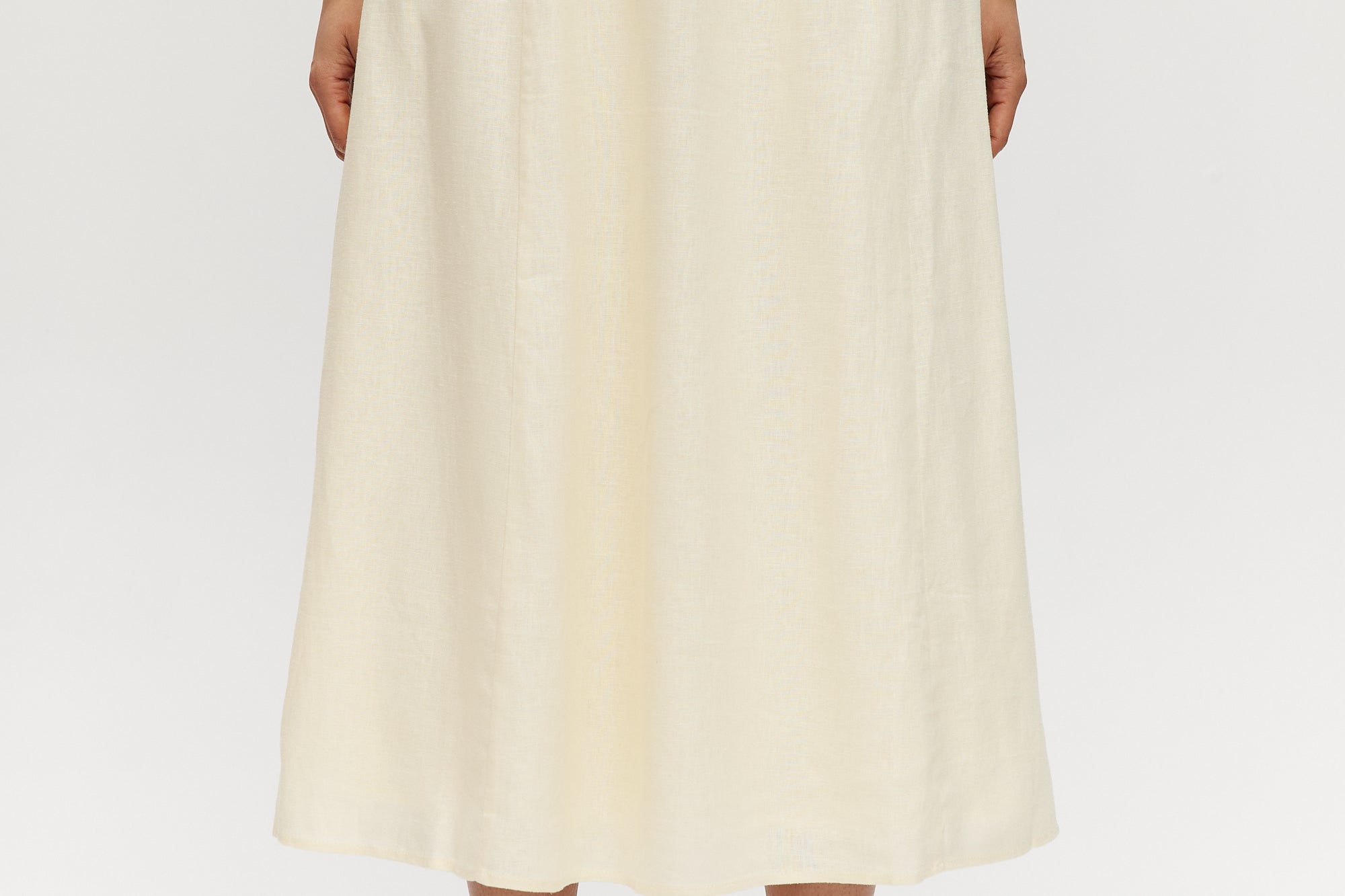 Yellow pleated linen blend midi skirt featuring pockets and an elastic waistband by Hilary Radley.