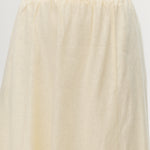 Yellow pleated linen blend midi skirt featuring pockets and an elastic waistband by Hilary Radley.