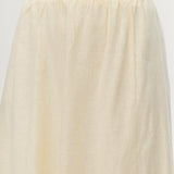 Yellow pleated linen blend midi skirt featuring pockets and an elastic waistband by Hilary Radley.