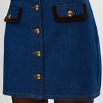 Blue Contrast Trim Denim Mini Skirt featuring vegan leather trim and gold buttons by Hilary Radley.