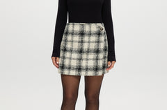 Cream plaid A-line mini skirt with decorative pearl button and boucle texture.