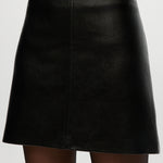 Black vegan leather A-line skirt featuring a high waist and comfort waistband by Hilary Radley.