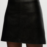 Black vegan leather A-line skirt featuring a high waist and comfort waistband by Hilary Radley.