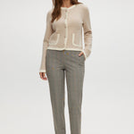 Beige knit cardigan with round collar and contrast trim by Hilary Radley.
