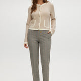 Beige knit cardigan with round collar and contrast trim by Hilary Radley.