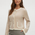 Beige knit cardigan with round collar and contrast trim