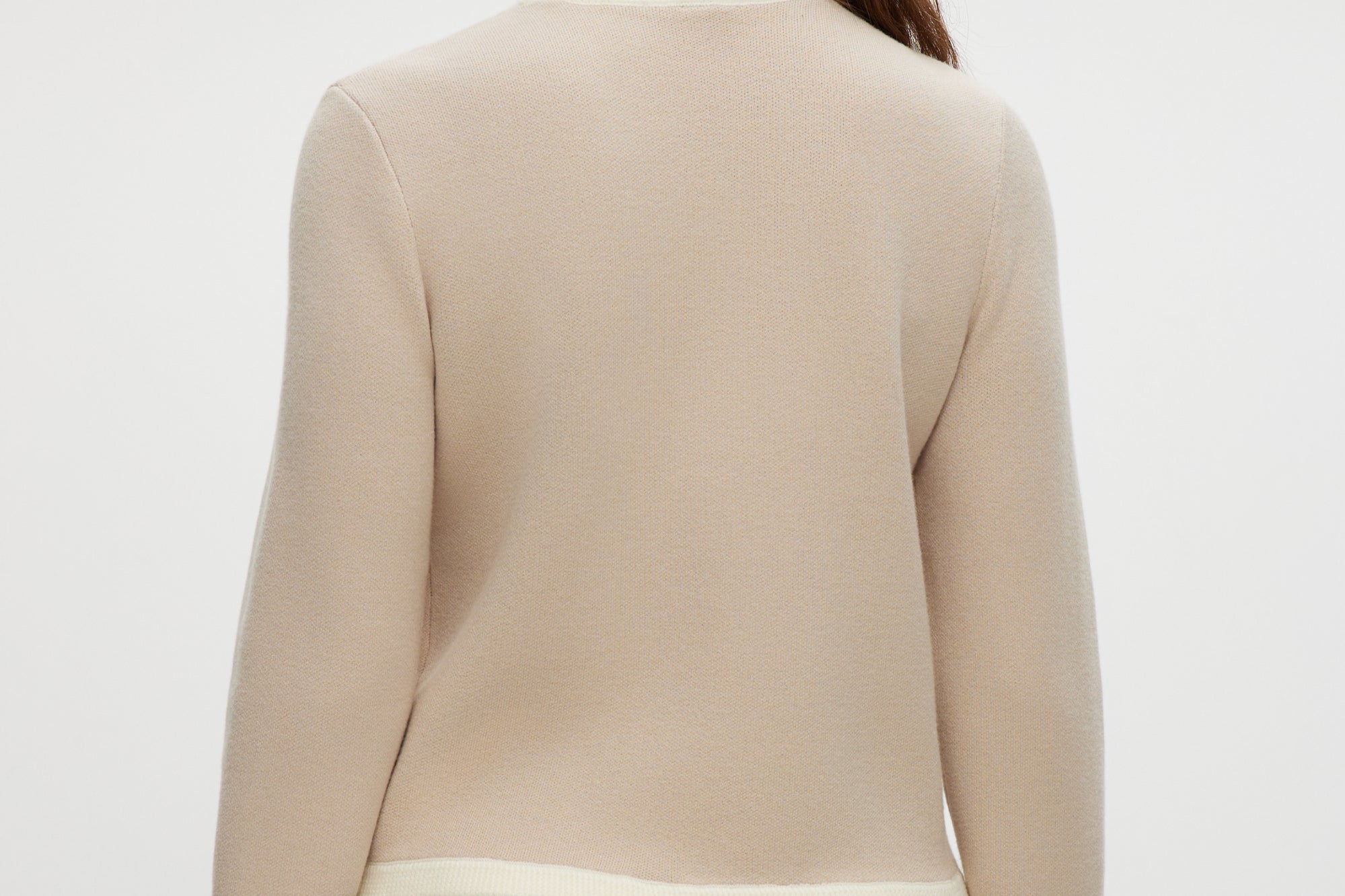 Beige knit cardigan featuring a round collar and contrast trim, available from Hilary Radley.