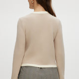 Beige knit cardigan featuring a round collar and contrast trim, available from Hilary Radley.