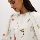 Ivory floral linen blend blouse featuring 3/4 sleeves and button-front closure by Hilary Radley.
