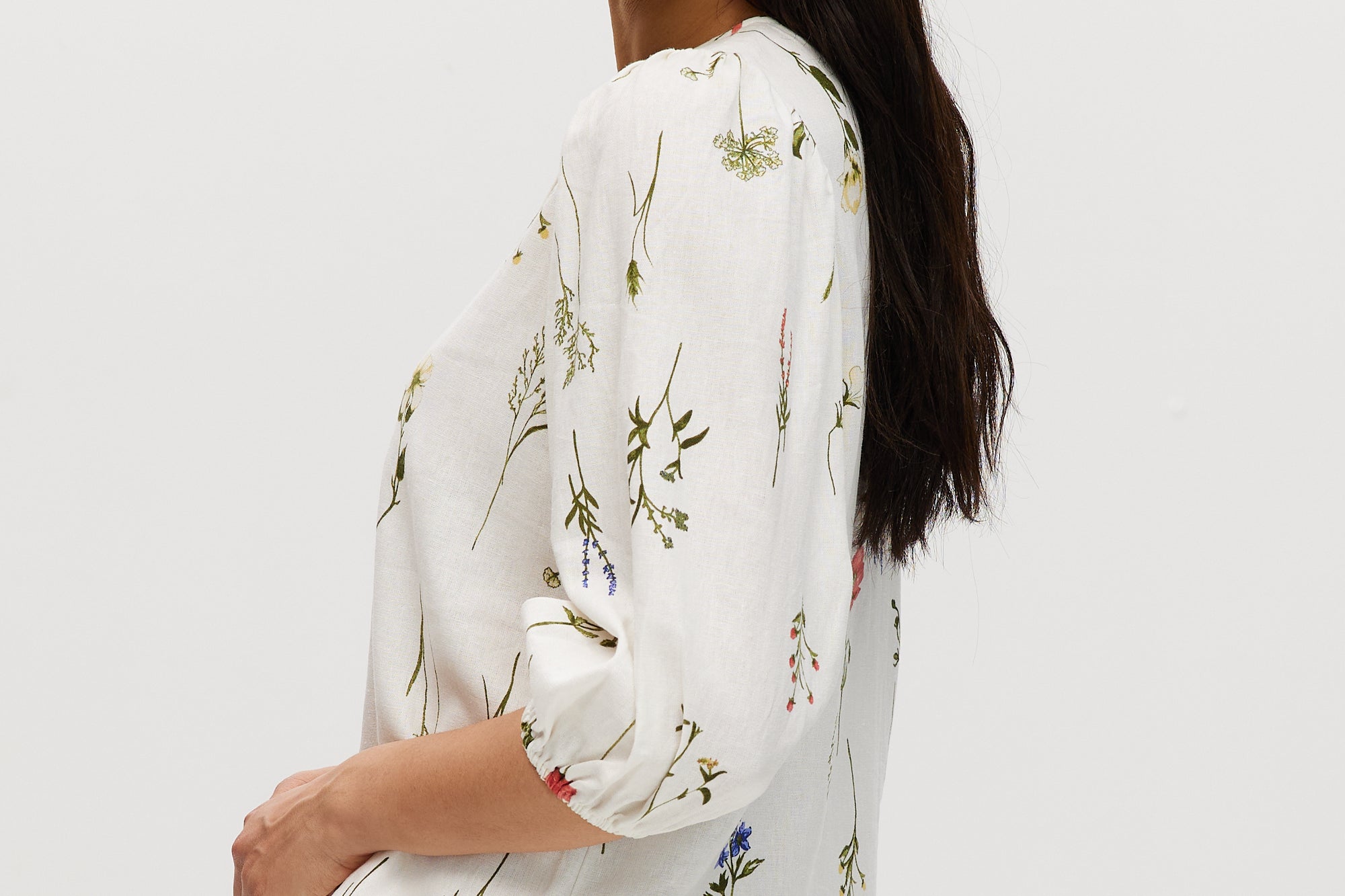 Ivory floral linen blend blouse featuring 3/4 sleeves and button-front closure by Hilary Radley.