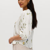 Ivory floral linen blend blouse featuring 3/4 sleeves and button-front closure by Hilary Radley.