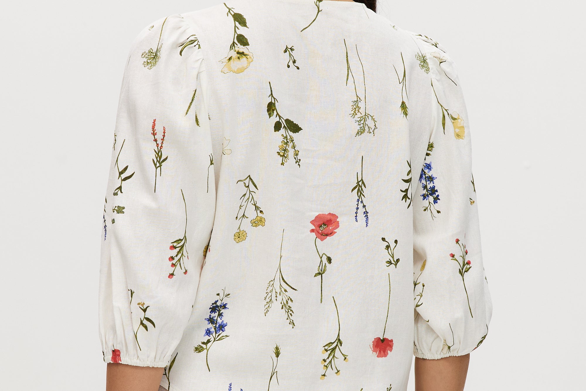 Ivory floral linen blend blouse featuring 3/4 sleeves and button-front closure by Hilary Radley.