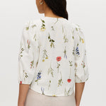 Ivory floral linen blend blouse featuring 3/4 sleeves and button-front closure by Hilary Radley.