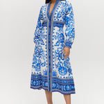 White and Blue Floral Linen Blend Midi Shirt Dress featuring a V-neckline, button front, crochet trim, and puff sleeves by Hilary Radley.