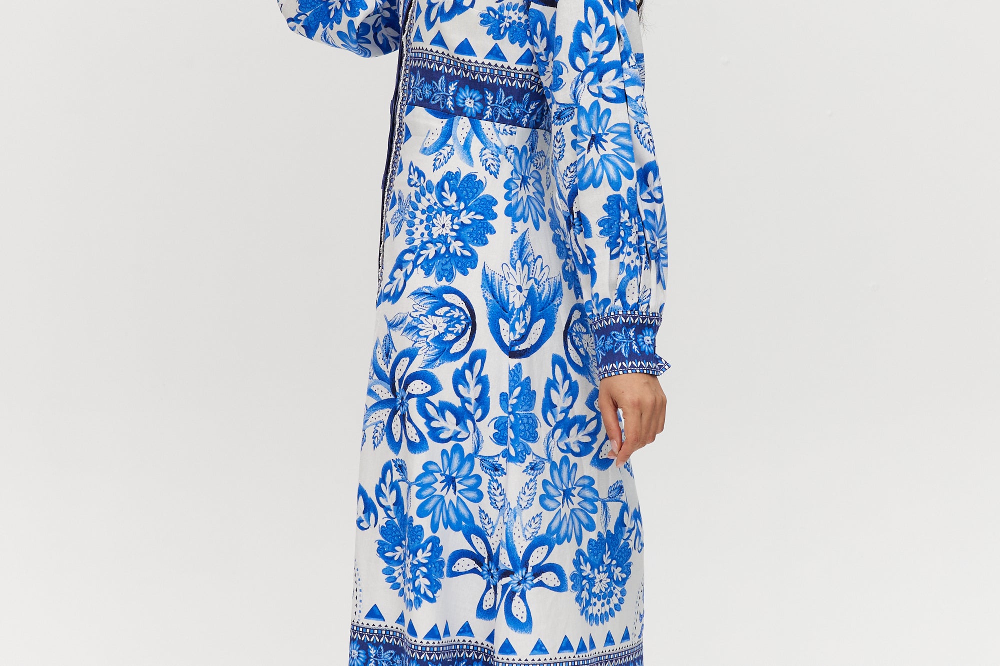 White and Blue Floral Linen Blend Midi Shirt Dress featuring a V-neckline, button front, crochet trim, and puff sleeves by Hilary Radley.
