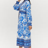 White and Blue Floral Linen Blend Midi Shirt Dress featuring a V-neckline, button front, crochet trim, and puff sleeves by Hilary Radley.