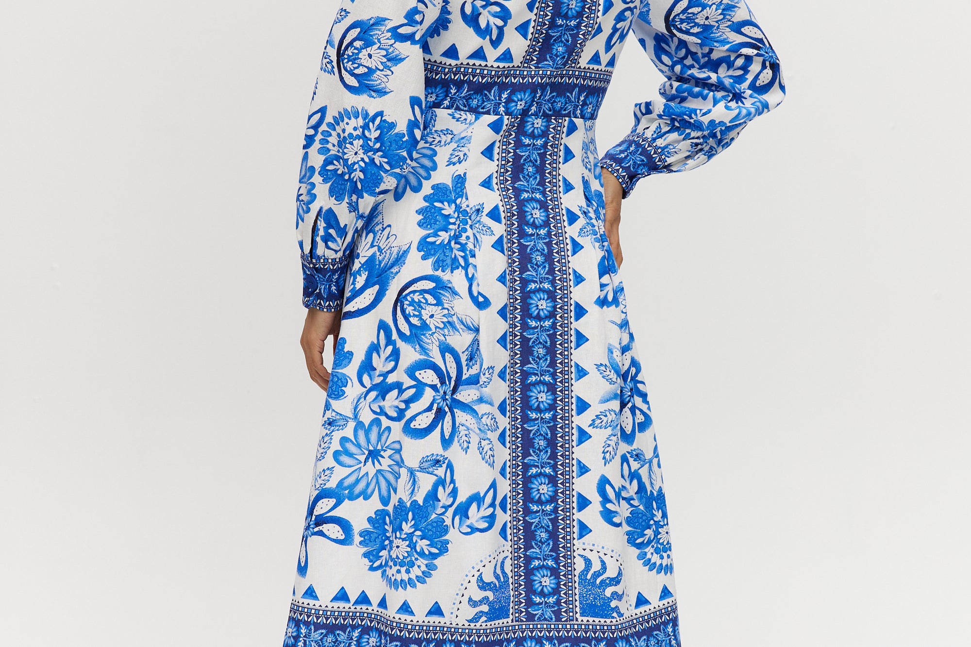 White and Blue Floral Linen Blend Midi Shirt Dress featuring a V-neckline, button front, crochet trim, and puff sleeves by Hilary Radley.