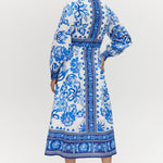 White and Blue Floral Linen Blend Midi Shirt Dress featuring a V-neckline, button front, crochet trim, and puff sleeves by Hilary Radley.