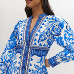 White and Blue Floral Linen Blend Midi Shirt Dress featuring a V-neckline, button front, crochet trim, and puff sleeves by Hilary Radley.