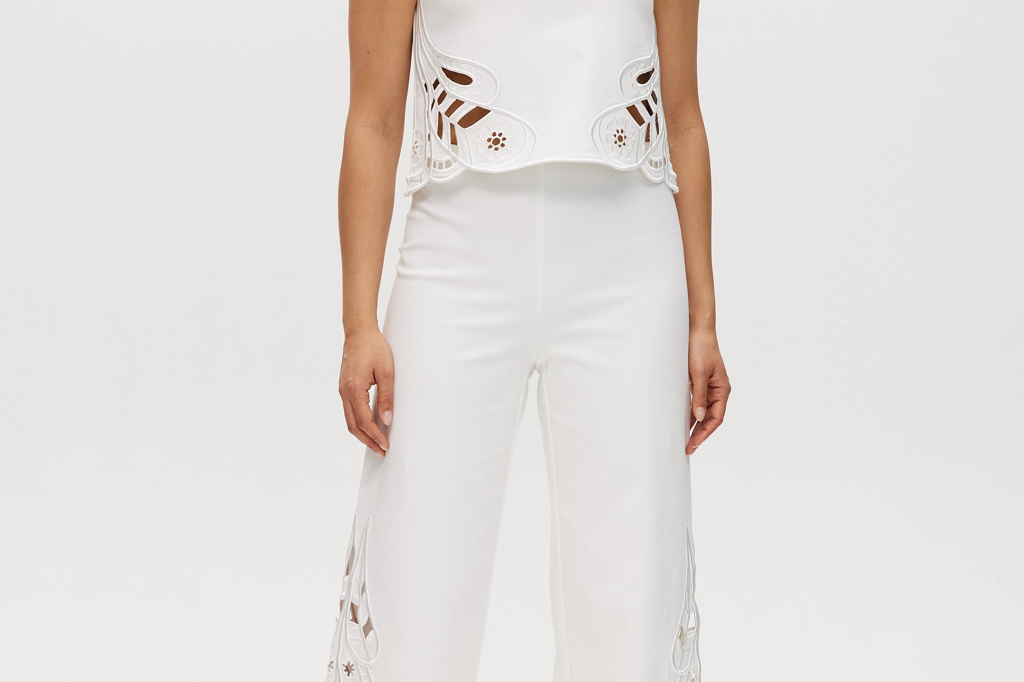 Off-White sleeveless top featuring embroidered cotton with button-back closure by Hilary Radley.