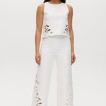 Off-White sleeveless top featuring embroidered cotton with button-back closure by Hilary Radley.