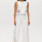 Off-White sleeveless top featuring embroidered cotton with button-back closure by Hilary Radley.