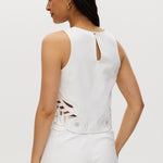 Off-White sleeveless top featuring embroidered cotton design and button-back closure by Hilary Radley.