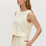 Yellow sleeveless cropped top featuring a crew neckline and tie-back detail by Hilary Radley.