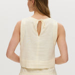 Yellow sleeveless cropped top featuring a crew neckline and tie-back detail by Hilary Radley.