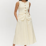 Light cream sleeveless top with button-front and waist tab detail by Hilary Radley.