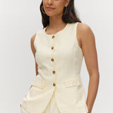 Light cream sleeveless top with button-front and waist tab detail.