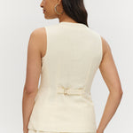 Light cream sleeveless top featuring a button-front and waist tab detail, available from Hilary Radley.