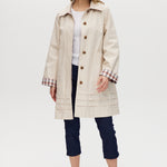 Cream Reversible Plaid & Solid Trench Jacket featuring a button-front closure and relaxed fit, available from Hilary Radley.