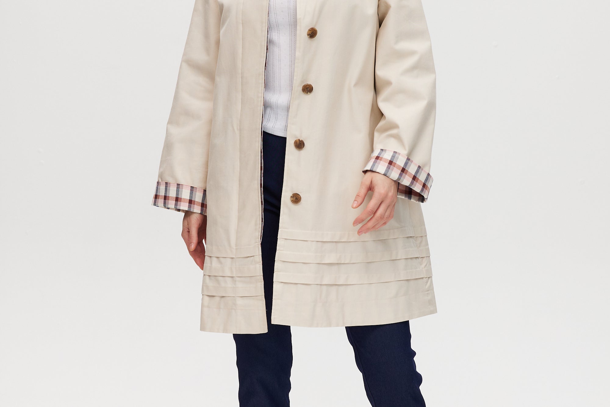 Cream reversible utility jacket with plaid and solid sides, button-front closure, and relaxed fit.