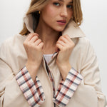 Cream reversible trench jacket with plaid and solid sides, featuring a button-front closure and relaxed fit by Hilary Radley.