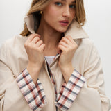 Cream reversible trench jacket with plaid and solid sides, featuring a button-front closure and relaxed fit by Hilary Radley.