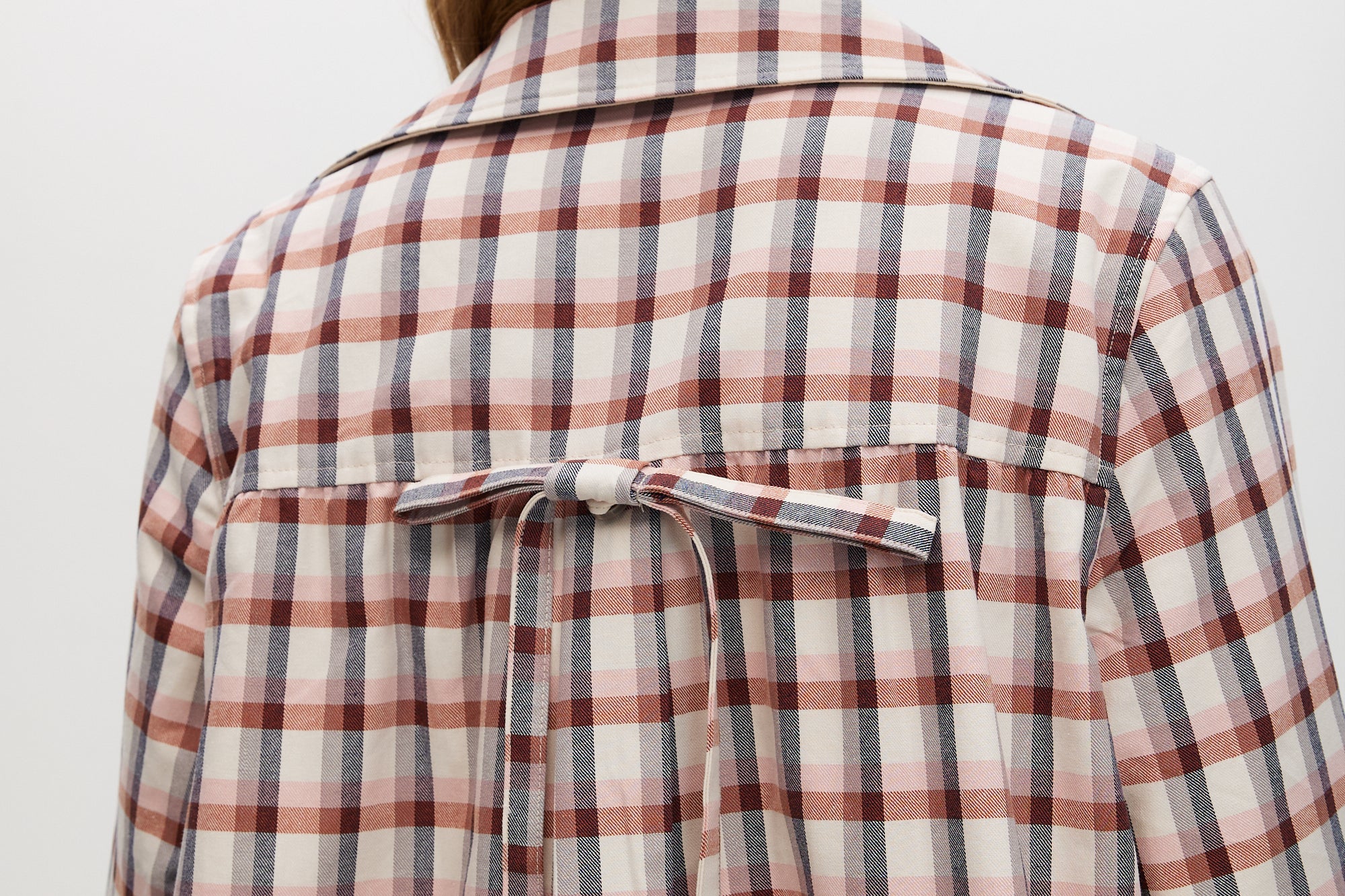 Cream Reversible Plaid & Solid Trench Jacket featuring a button-front closure and relaxed fit by Hilary Radley.
