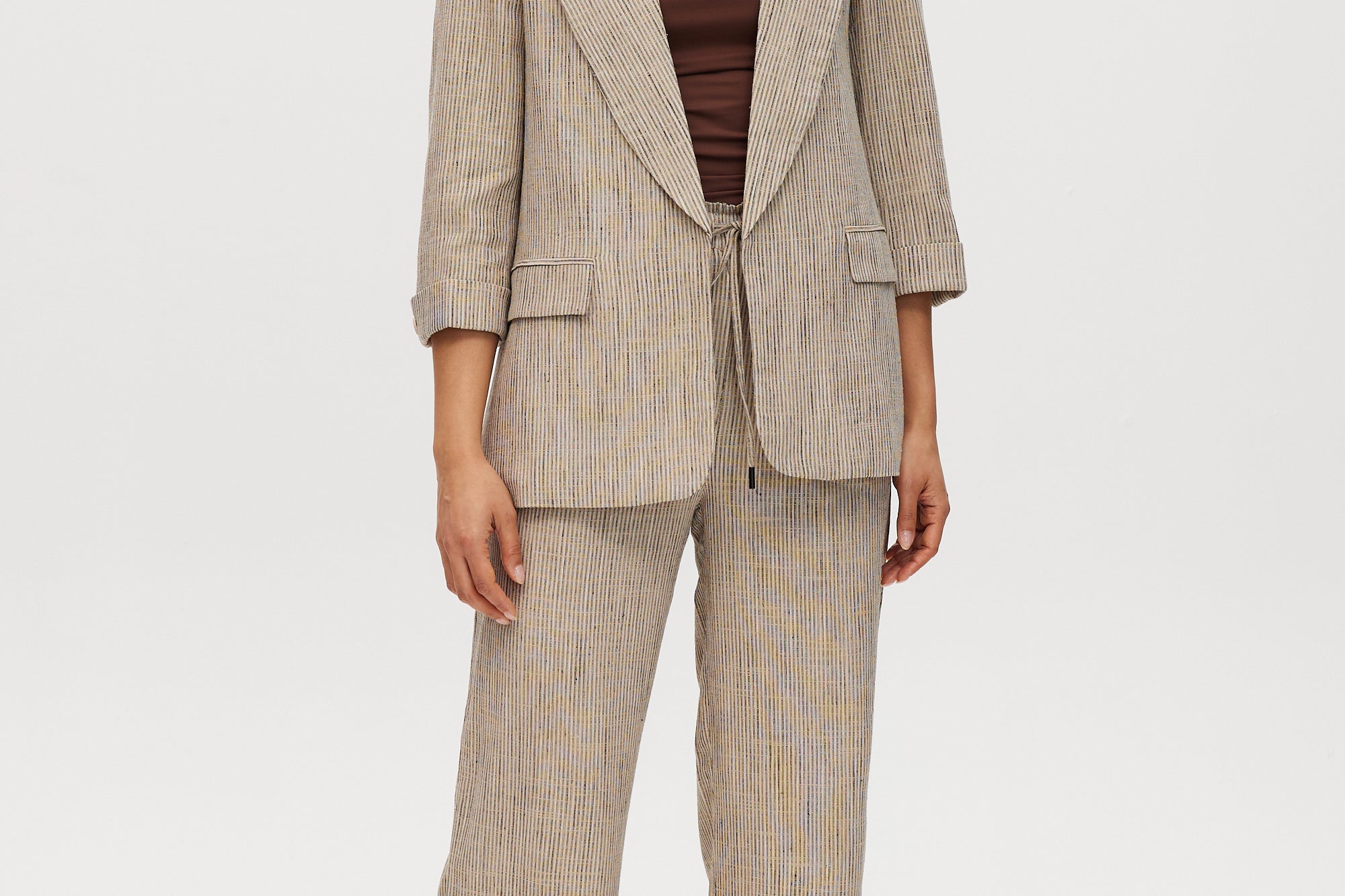 Beige striped yarn-dye linen blazer with 3/4 sleeves and lapel collar by Hilary Radley.