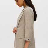 Beige striped yarn-dye linen blazer featuring 3/4 sleeves and a lapel collar by Hilary Radley.