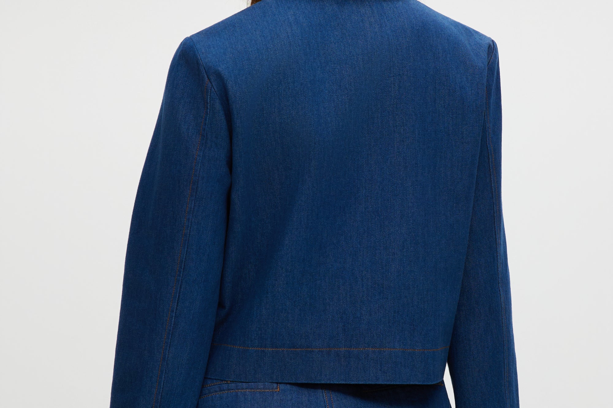 Blue Denim Jacket featuring contrast trim and gold buttons, available from Hilary Radley.
